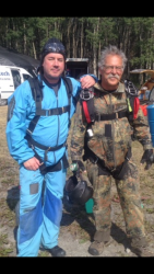 Wayne dressed for skydiving, posing with Barry Cyr