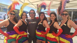 Wayne posing with five cancan dancers